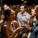 Couples Dancing And Drinking At Evening Party